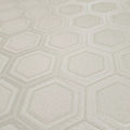Textured wallpaper with a geometric hexagonal pattern in light gray.