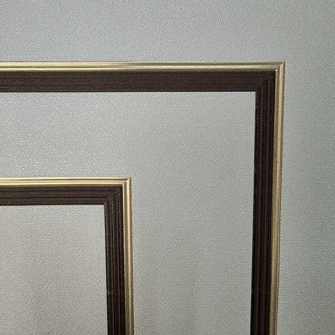 Decorative wallpaper with geometric patterns on a light gray background