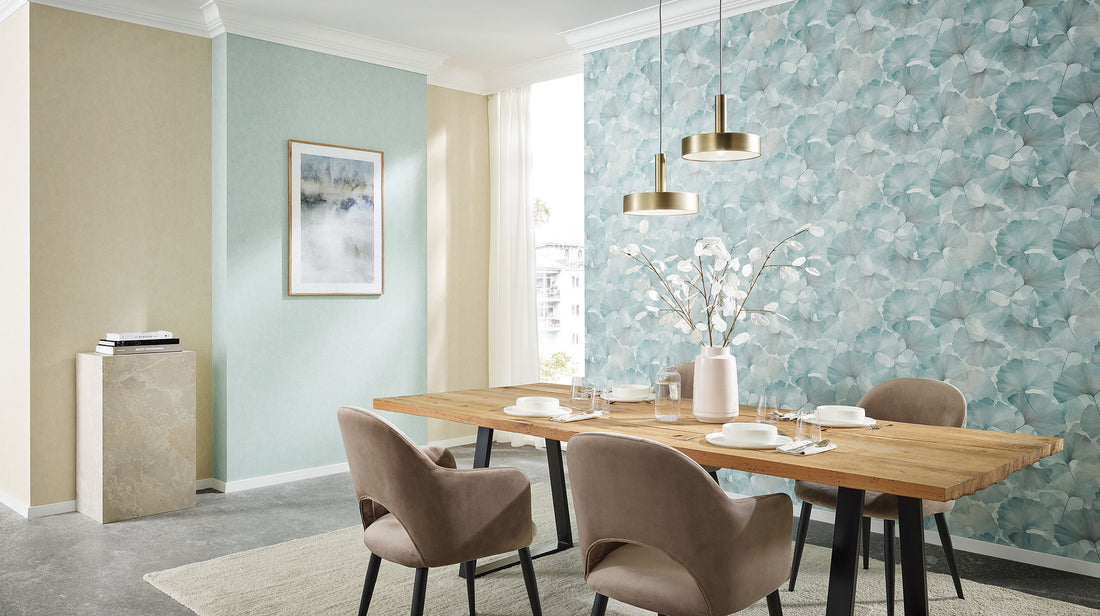Erismann Elysium botanical wallpaper featuring delicate ginkgo leaves in soft sage green tones layered over a light neutral background, creating a fresh, airy and calming natural aesthetic.