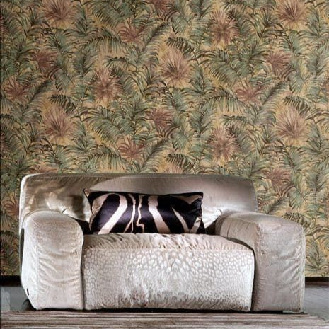Patterned wallpaper with a palm leaf design and a beige sofa with a zebra print pillow.
