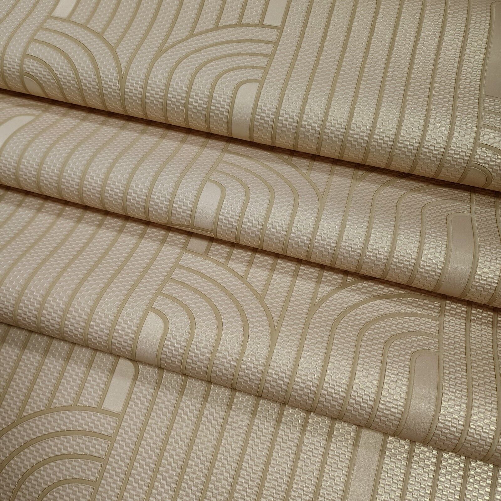 Textured wallpaper rolls with wavy line pattern in beige tones